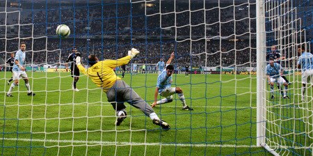 MUNICH, GERMANY - OCTOBER 28:  Benedikt Hoewedes (2nd R) of Schalke scores his team's second goal against goalkeeper Gabor Kiraly of 1860 during the DFB Cup round of 16 match between 1860 Muenchen and FC Schalke 04 at Allianz Arena on October 28, 2009 in Munich, Germany.  <br /><br /><span class="help">(Photo by Alexander Hassenstein/Bongarts/Getty Images)</span>