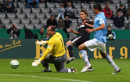 MUNICH, GERMANY - OCTOBER 28:  Rafinha (C) of Schalke scores his team's first goal against goalkeeper Gabor Kiraly (L) of 1860 and his team mate Jose Holebas (R) during the DFB Cup round of 16 match between 1860 Muenchen and FC Schalke 04 at Allianz Arena on October 28, 2009 in Munich, Germany.  <br /><br /><span class="help">(Photo by Alexander Hassenstein/Bongarts/Getty Images)</span>