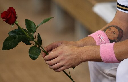 MILWAUKEE - MAY 10:  Corey Hart #1 of the Milwaukee Brewers holds a rose to be given to a Mother and wears pink wrist bands on "Going to Bat Against Breast Cancer" day before a game against the Chicago Cubs on May 10, 2009 at Miller Park in Milwaukee, Wisconsin.  <br /><br /><span class="help">(Photo by Jonathan Daniel/Getty Images)</span>