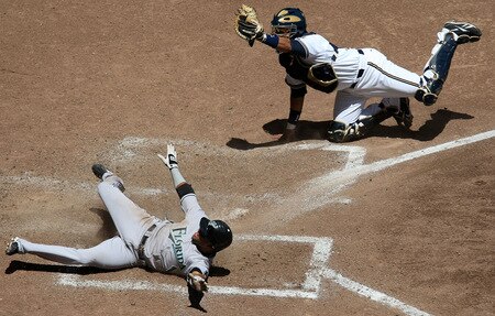MILWAUKEE - MAY 14: Catcher Mike Rivera #11 (R) of the Milwaukee Brewers shows the ball to the umpire after tagging out Emilio Bonifacio #1 of the Florida Marlins in the 5th inning on May 14, 2009 at Miller Park in Milwaukee, Wisconsin. <br /><br /><span class="help">(Photo by Jonathan Daniel/Getty Images)</span>