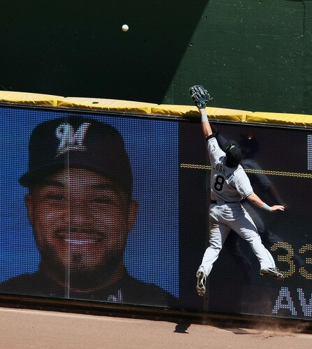 MILWAUKEE - MAY 14: Chris Coghlan #8 of the Florida Marlins leaps in vain to try and catch a home run ball hit by Prince Fielder of the Milwaukee Brewers, whose photo appears on the outfield view screen, on May 14, 2009 at Miller Park in Milwaukee, Wisconsin. <br /><br /><span class="help">(Photo by Jonathan Daniel/Getty Images)</span>