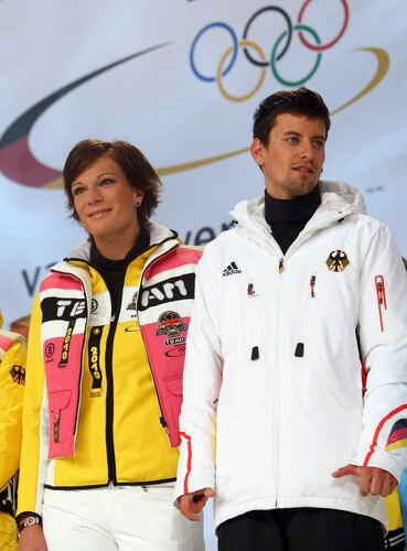 MUNICH, GERMANY - OCTOBER 29: Ski alpine athlete Maria Riesch (L) walks with Nordic combined athelte Bjoern Kircheisen on the catwalk during the presentation of the German athletes Winter Olympic kit at the Olympia Event Arena on October 29, 2009 in Munich, Germany.  <br /><br /><span class="help">(Photo by Alexander Hassenstein/Bongarts/Getty Images)</span>