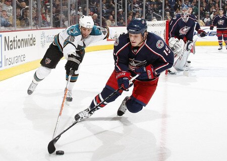 COLUMBUS, OH - NOVEMBER 04:  Derek Dorsett #15 of the Columbus Blue Jackets tries to control the puck in front of Jody Shelley #45 of the San Jose Sharks on November 4, 2009 at Nationwide Arena in Columbus, Ohio.  <br /><br /><span class="help">(Photo by Gregory Shamus/Getty Images)</span>