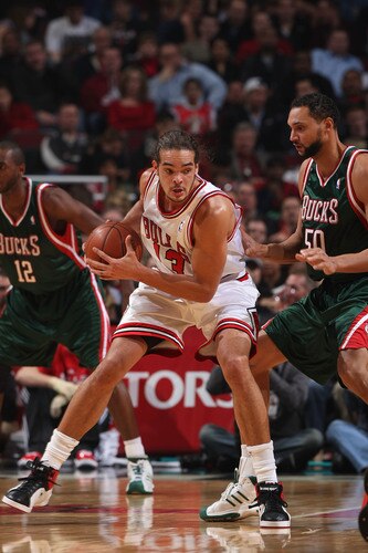 CHICAGO -  NOVEMBER 03:  Joakim Noah #13 of the Chicago Bulls posts up against Dan Gadzuric #50 of the Milwaukee Bucks on November 3, 2009 at the United Center in Chicago, Illinois.  <br /><br /><span class="help">(Photo by Gary Dineen/NBAE via Getty Images)</span>