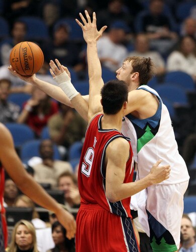 MINNEAPOLIS, MN - OCTOBER 28: Oleksiy Pecherov #4 of the Minnesota Timberwolves scores over Yi Jianlian #9 of the New Jersey Nets in the third quarter at the Target Center on October 28, 2009 in Minneapolis, Minnesota. <br /><br /><span class="help">(Photo by Genevieve Ross/Getty Images)</span>