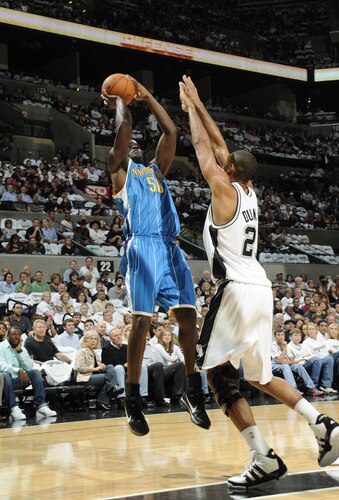SAN ANTONIO - OCTOBER 28: Emeka Okafor #50 of the New Orleans Hornets shoots against Tim Duncan #21 of the San Antonio Spurs on October 28, 2009 at the AT&T Center in San Antonio, Texas. <br /><br /><span class="help">(Photo by D. Clarke Evans/NBAE via Getty Images)</span>