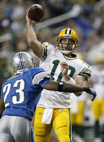 DETROIT , MI - NOVEMBER 26:  Aaron Rodgers #12 of the Green Bay Packers throws a third quarter touchdown behind Kevin Hobbs #23 of the Detroit Lions on November 26, 2009 at Ford Field in Detroit, Michigan. Green Bay won the game 34-12. <br /><br /><span class="help">(Photo by Gregory Shamus/Getty Images)</span>