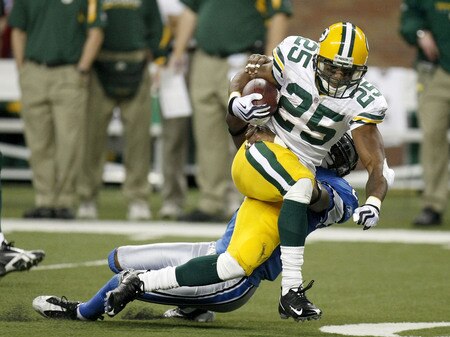 DETROIT , MI - NOVEMBER 26:  Ryan Grant #25 of the Green Bay Packers tries to break the tackle of Marvin White #25 of the Detroit Lions on November 26, 2009 at Ford Field in Detroit, Michigan. Green Bay won the game 34-12.  <br /><br /><span class="help">(Photo by Gregory Shamus/Getty Images)</span>