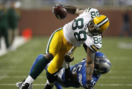 DETROIT , MI - NOVEMBER 26: Jermichael Finley #88 of the Green Bay Packers is pulled down with a horse collar tackle by Marvin White #25 of the Detroit Lions on November 26, 2009 at Ford Field in Detroit, Michigan.  <br /><br /><span class="help">(Photo by Gregory Shamus/Getty Images)</span>