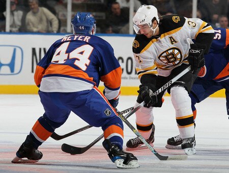 UNIONDALE, NY - DECEMBER 12:  Freddy Meyer #44 of the New York Islanders defends against Patrice Bergeron #37 of the Boston Bruins during their game at the Nassau Coliseum on December 12, 2009 at the Nassau Coliseum in Uniondale, New York.  <br /><br /><span class="help">(Photo by Al Bello/Getty Images)</span>
