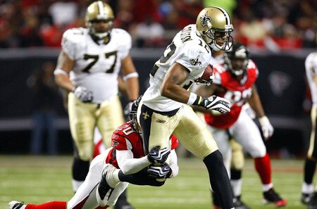 ATLANTA - DECEMBER 13:  Marques Colston #12 of the New Orleans Saints attempts to break a tackle by Brent Grimes #20 of the Atlanta Falcons at Georgia Dome on December 13, 2009 in Atlanta, Georgia.  The Saints won 26-23. <br /><br /><span class="help">(Photo by Kevin C. Cox/Getty Images)</span>