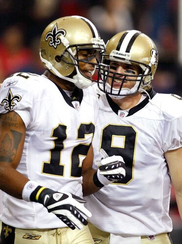 ATLANTA - DECEMBER 13:  Marques Colston #12 and quarterback Drew Brees #9 of the New Orleans Saints celebrate Colston's 3-yard touchdown reception in the second quarter against the Atlanta Falcons at Georgia Dome on December 13, 2009 in Atlanta, Georgia.  <br /><br /><span class="help">(Photo by Kevin C. Cox/Getty Images)</span>