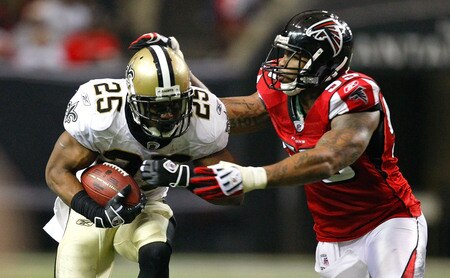 ATLANTA - DECEMBER 13:  Reggie Bush #25 of the New Orleans Saints runs the ball against John Abraham #55 of the Atlanta Falcons at Georgia Dome on December 13, 2009 in Atlanta, Georgia. The Saints won 26-23. <br /><br /><span class="help">(Photo by Kevin C. Cox/Getty Images)</span>