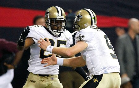 ATLANTA - DECEMBER 13:  Reggie Bush #25 and quarterback Drew Brees #9 (R) of the New Orleans Saints celebrate after they connected for a 6-yard touchdown reception in the second quarter against the Atlanta Falcons at Georgia Dome on December 13, 2009 in Atlanta, Georgia.  <br /><br /><span class="help">(Photo by Kevin C. Cox/Getty Images)</span>