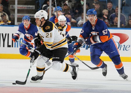 UNIONDALE, NY - DECEMBER 12: Andrew Ference #21 of the Boston Bruins skates with the puck against The New York Islanders during their game at the Nassau Coliseum on December 12, 2009 at the Nassau Coliseum in Uniondale, New York.  <br /><br /><span class="help">(Photo by Al Bello/Getty Images)</span>
