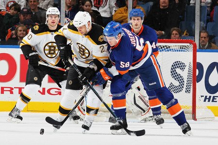 UNIONDALE, NY - DECEMBER 12:  Jesse Joensuu #58 of the New York Islanders battles for the puck with Steve Begin #27 of the Boston Bruins during their game at the Nassau Coliseum on December 12, 2009 at the Nassau Coliseum in Uniondale, New York.  <br /><br /><span class="help">(Photo by Al Bello/Getty Images)</span>