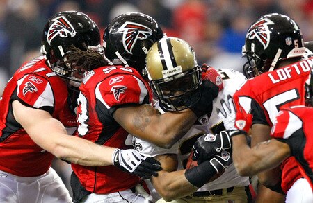 ATLANTA - DECEMBER 13:  Reggie Bush #25 of the New Orleans Saints is tackled by Kroy Biermann #71, Mike Peterson #53 and Curtis Lofton #50 of the Atlanta Falcons in the first half at Georgia Dome on December 13, 2009 in Atlanta, Georgia.  <br /><br /><span class="help">(Photo by Kevin C. Cox/Getty Images)</span>