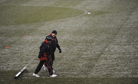 STOKE ON TRENT, ENGLAND - JANUARY 05:  Groundstaff try and keep the pitch clear of snow during the Barclays Premier League match between Stoke City and Fulham at The Britannia Stadium on January 5, 2010 in Stoke on Trent, England.  <br /><br /><span class="help">(Photo by Laurence Griffiths/Getty Images)</span>