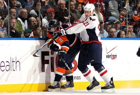 UNIONDALE, NY - JANUARY 26:  Brooks Laich #21 of the Washington Capitals defends against Mark Streit #2 of the New York Islanders on January 26, 2010 at Nassau Coliseum in Uniondale, New York.  <br /><br /><span class="help">(Photo by Jim McIsaac/Getty Images)</span>