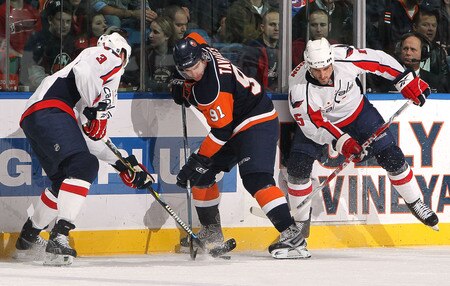 UNIONDALE, NY - JANUARY 26:  Tom Poti #3 and Boyd Gordon #15 of the Washington Capitals double team John Tavares #91 of the New York Islanders on January 26, 2010 at Nassau Coliseum in Uniondale, New York.  <br /><br /><span class="help">(Photo by Jim McIsaac/Getty Images)</span>