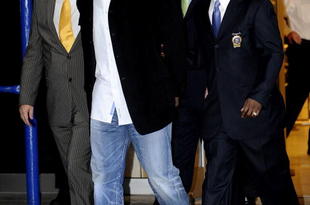 NEW YORK - DECEMBER 1:  Wide receiver Plaxico Burress (2L) of the New York Giants is led to a squad car for transport to his arraignment outside the NYPD 17th Precinct December 1, 2008 in New York City. Burress, who is expected to face a charge of criminal possession of a weapon, was released from the hospital yesterday after accidentally shooting himself in the right thigh at a nightclub in Manhattan on the night of November 28.  (Photo by Jeff Zelevansky/Getty Images)