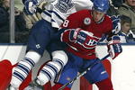 TORONTO - NOVEMBER 11:   Alexei Ponikarovsky #23 of the Toronto Maple Leafs checks Mike Komisarek #8 of the Montreal Canadiens during their NHL game at the Air Canada Centre on November 11, 2006 in Toronto, Ontario. The Leafs beat the Canadiens 5-1.  (Photo By Dave Sandford/Getty Images)