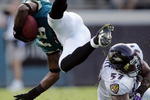 JACKSONVILLE, FL - NOVEMBER 13:  Linebacker Bart Scott #57 of the Baltimore Ravens trips up Ernest Wilford #19 of the Jacksonville Jaguars at Alltel Stadium November 13, 2005 in Jacksonville, Florida.  (Photo by Doug Benc/Getty Images)