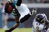 JACKSONVILLE, FL - NOVEMBER 13:  Linebacker Bart Scott #57 of the Baltimore Ravens trips up Ernest Wilford #19 of the Jacksonville Jaguars at Alltel Stadium November 13, 2005 in Jacksonville, Florida.  (Photo by Doug Benc/Getty Images)
