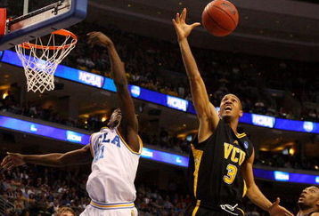PHILADELPHIA - MARCH 19:  Eric Maynor #3 of the VCU Rams rebounds against Jrue Holiday #21 of the UCLA Bruins during the first round of the NCAA Division I Men's Basketball Tournament at the Wachovia Center on March 19, 2009 in Philadelphia, Pennsylvania.  (Photo by Jim McIsaac/Getty Images)