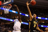 PHILADELPHIA - MARCH 19:  Eric Maynor #3 of the VCU Rams rebounds against Jrue Holiday #21 of the UCLA Bruins during the first round of the NCAA Division I Men's Basketball Tournament at the Wachovia Center on March 19, 2009 in Philadelphia, Pennsylvania.  (Photo by Jim McIsaac/Getty Images)