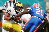ORLANDO, FL - JANUARY 01:  Running back Mike Hart #20 of the Michigan Wolverines tries to avoid a tackle attempt by safety Major Wright #21of  the Florida Gators in the Capital One Bowl at Florida Citrus Bowl on January 1, 2008 in Orlando, Florida. Michigan defeated Florida 41-35.  (Photo by Doug Benc/Getty Images)