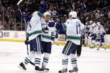 LOS ANGELES, CA - MARCH 10:  (L-R) Willie Mitchell #8, Kevin Bieksa #3 and Ryan Kesler #17 of the Vancouver Canucks celebrate Kesler's game winning goal in overtime against the Los Angeles Kings at Staples Center on March 10, 2008 in Los Angeles, California.  The Canucks defeated the Kings 2-1 in overtime.  (Photo by Jeff Gross/Getty Images)