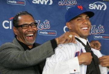 LONG ISLAND CITY, NY - DECEMBER 17:  New York Mets Manager Jerry Manuel helps Francisco Rodriquez put on a Mets jersey for the first time during a press conference to introduce him on December 17, 2008 at the Citigroup Building in New York City.  (Photo by Mike Stobe/Getty Images)