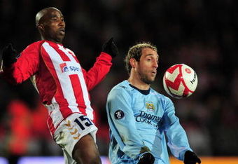 AALBORG, DENMARK - MARCH 19:  Pablo Zabaleta of Manchester City is challenged by Siyabonga Nomvethe of Aalborg during the UEFA Cup, Round of 16, Second Leg match between Aalborg and Manchester City on March 19, 2009 in Aalborg, Denmark.  (Photo by Stuart Franklin/Getty Images)