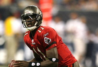 HOUSTON - AUGUST 28:  Quarterback  Josh Johnson #11 of the Tampa Bay Buccaneers rolls out looking down-field for a receiver against the Houston Texans Aug. 28, 2008 at Reliant Stadium in Houston, Texas.  (Photo by Bob Levey/Getty Images)