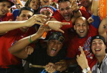 SAN JUAN, PUERTO RICO - MARCH 11:  Fans of Puerto Rico cheer against The Netherlands during the 2009 World Baseball Classic Pool D match on March 11, 2009 at Hiram Bithorn Stadium in San Juan, Puerto Rico.  (Photo by Al Bello/Getty Images)
