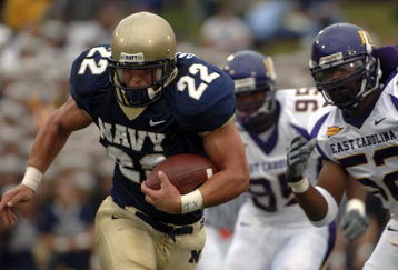 ANNAPOLIS, MD - SEPTEMBER 02:  In this handout photo Adam Ballard #22 of the Navy Midshipman is chased by Jarrett Wiggins #52 and C.J. Wilson #95 of the East Carolina Pirates in the first half of play at Navy-Marine Corps Memorial Stadium September 02, 2006 in Annapolis, Maryland.  (Photo by Damon J. Moritz/U.S. Navy via Getty Images)