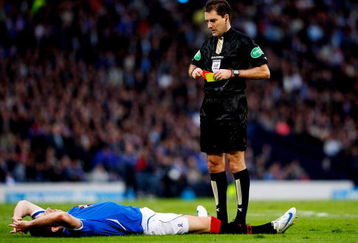 GLASGOW, UNITED KINGDOM - MARCH 15:  Rangers player Kirk Broadfoot lays down before being sent off by referee Douglas Mcdonald after fouling Celtic player Aiden Mcgeady in the penalty box for a penalty during the CIS Insurance Cup Final between Rangers and Celtic at Hampden Park on March 15, 2009 in Glasgow, Scotland.  (Photo by Stu Forster/Getty Images)