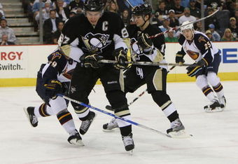 PITTSBURGH - MARCH 17: Sidney Crosby #87 of the Pittsburgh Penguins skates around Tobias Enstrom #39 of the Atlanta Thrashers on March 17, 2009 at the Mellon Arena in Pittsburgh, Pennsylvania. The Penguins defeated the Thrashers 6-2. (Photo by Bruce Bennett/Getty Images)
