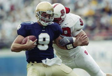 JACKSONVILLE, FL - JANUARY 1:  Quarterback Pat Dillingham #9 of the Notre Dame Fighting Irish is sacked by Defensive end Drew Wimsatt #99 of the North Carolina State University Wolfpack during the Toyota Gator Bowl at Alltel Stadium on January 1, 2003 in Jacksonville, Florida. The Wolfpack defeated the Fighting Irish 28-6. (Photo by Craig Jones/Getty Images)