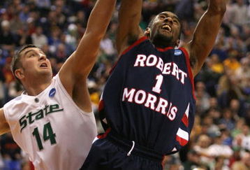 MINNEAPOLIS - MARCH 20:  Rob Robinson #1 of the Robert Morris Colonials drives for a shot attempt against Goran Suton #14 of the Michigan State Spartans during the first round of the NCAA Division I Men's Basketball Tournament at the Hubert H. Humphrey Metrodome on March 20, 2009 in Minneapolis, Minnesota.  (Photo by Jonathan Daniel/Getty Images)
