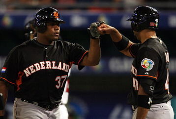 MIAMI - MARCH 15:  Bryan Engelhardt #37 of the Netherlands is congratulated by Vince Rooi #41 after hitting a solo home run in the eighth inning against the United States during round 2 of the World Baseball Classic at Dolphin Stadium on March 15, 2009 in Miami, Florida. The United States eliminated the Netherlands 9-3.  (Photo by Doug Benc/Getty Images)