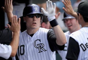DENVER - JULY 20:  Jeff Baker #10 of the Colorado Rockies is welcomed into the duggout after his two run homerun off of starting pitcher Zach Duke of the Pittsburgh Pirates in the fifth inning at Coors Field on July 20, 2008 in Denver, Colorado. The homerun gave the Rockies a 5-3 lead.  (Photo by Doug Pensinger/Getty Images)