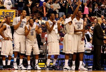 PHILADELPHIA - MARCH 21:  Kemba Walker #15, Jonathan Mandeldove #32, A.J. Price #12,  Stanley Robinson #21, Jeff Adrien #4 and Hasheem Thabeet #34 of the Connecticut Huskies show camaraderie for their team during the game against the Texas A&M Aggies during the second round of the NCAA Division I Men's Basketball Tournament at the Wachovia Center on March 21, 2009 in Philadelphia, Pennsylvania.  The Huskies defeated the Aggies 92-66.  (Photo by Jim McIsaac/Getty Images)