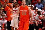 NEW YORK - MARCH 14: Eric Devendorf #23 of the Syracuse Orange reacts between as Edgar Sosa #10 the Louisville Cardinals looks on during the championship game of the Big East Tournament at Madison Square Garden on March 14, 2009 in New York City.  (Photo by Jim McIsaac/Getty Images)