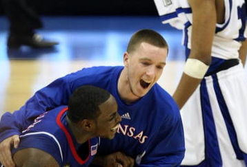 SAN ANTONIO - APRIL 07:  Sherron Collins #4 of the Kansas Jayhawks is jumped on by teammate Brady Morningstar #12 as they react after the Jayhawks defeat the Memphis Tigers by a score of 75-68 in overtime during the 2008 NCAA Men's National Championship game at the Alamodome on April 7, 2008 in San Antonio, Texas.  (Photo by Jed Jacobsohn/Getty Images)