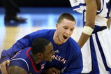 SAN ANTONIO - APRIL 07:  Sherron Collins #4 of the Kansas Jayhawks is jumped on by teammate Brady Morningstar #12 as they react after the Jayhawks defeat the Memphis Tigers by a score of 75-68 in overtime during the 2008 NCAA Men's National Championship game at the Alamodome on April 7, 2008 in San Antonio, Texas.  (Photo by Jed Jacobsohn/Getty Images)