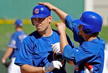 SURPRISE, AZ - FEBRUARY 27:  Micah Hoffpauir #6 (L) of the Chicago Cubs is congratulated by teammate Ryan Theriot #2 who scored on Hoffpauir's two-run home run against the Texas Rangers during a spring training game at the Surprise Stadium on February 27, 2009 in Surprise, Arizona.  (Photo by Kevork Djansezian/Getty Images)