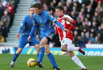STOKE, UNITED KINGDOM - FEBRUARY 21: Hermann Hreidarsson of Portsmouth is challenged by James Beattie of Stoke during the Barclays Premier League match between Stoke City and Portsmouth at The Britannia Stadium on February 21, 2009 in Stoke,England.  (Photo by Ross Kinnaird/Getty Images)