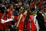 CLEVELAND - APRIL 01: (L-R) Kia Vaughn #15, Heather Zurich #21 and Matee Ajavon #22 of the Rutgers Scarlet Knights celebrate from the bench late inthe game against the LSU Lady Tigers during the National Semifinal game of the 2007 NCAA Women's Final Four at the Quicken Loans Arena on April 1, 2007 in Cleveland, Ohio. Rutgers won 59-35. (Photo by Gregory Shamus/Getty Images)